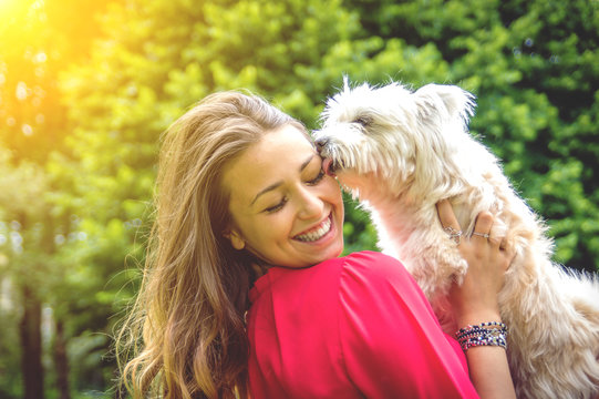 Attractive caucasian girl having fun with her dog