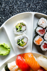 varieties of sushi and California roll. nigiri. wasabi.