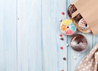 Colorful donuts in paper bag