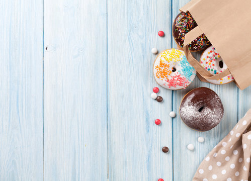 Colorful donuts in paper bag