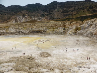 Stefanos crater. The volcano on the island of Nisyros. Greece. Tourists walking inside the crater.