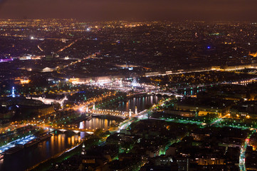 Aerial Night view of Paris City and Seine river shot on the top of Eiffel Tower