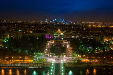 Fototapeta premium Aerial Night view of Paris City and Seine river shot on the top of Eiffel Tower