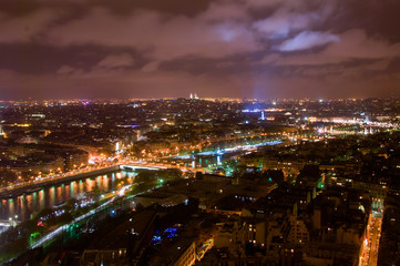 Aerial Night view of Paris City and Seine river shot on the top of Eiffel Tower