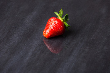 tasty strawberries isolated on black background, stone tile