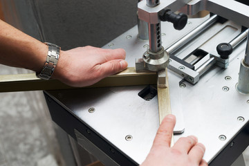 Craftsman working on frame in frameshop.