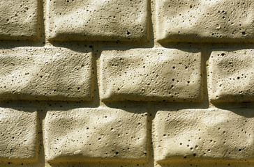Yellow brick stylized wall texture.