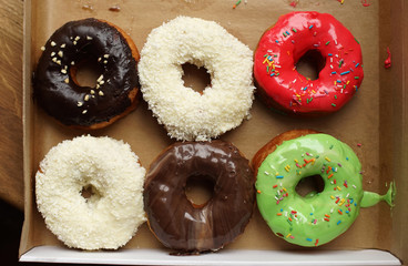 Colorful donuts in box. Top view.