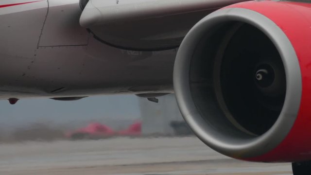 turbines of a plane moving on a runway in the airport. Close up view, Fog weather, 4k UHD 2160p