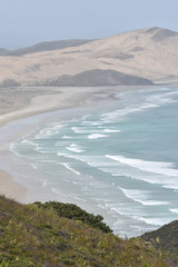 Naklejka premium Flat sandy beaches of most northern part of New Zealand at Cape Reinga.