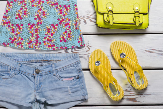 Yellow flip flops and shorts.