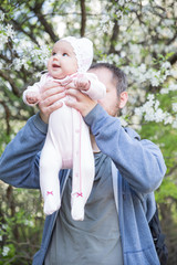 Father and daughter under tree. Soft focus