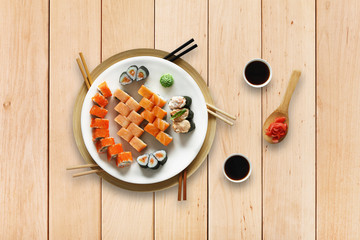 Set of sushi maki and rolls at wood.