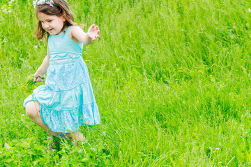 Beautiful child girl with dandelion flower in spring park. Happy