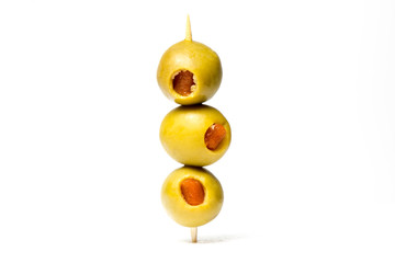 olives with toothpicks on white