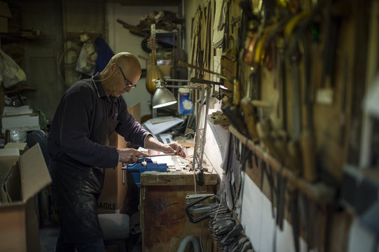 Luthier working in his workshop