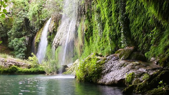 Waterfall flowing over mossy rock. Kursunlu waterfall  in Turkey.   