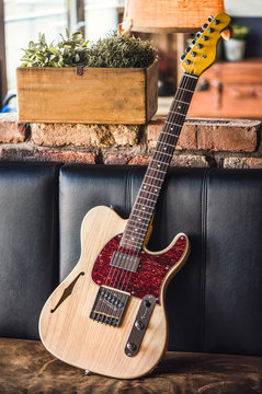 Electric Guitar Leaning Against a Couch