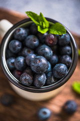 rustic cup with fresh blueberries