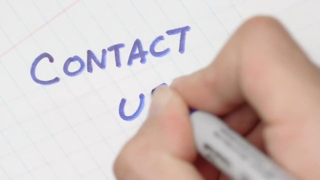 Contact us written with a pen.