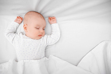 Beautiful sleeping baby in bed