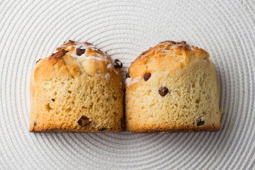 Homemade carrot muffin with empty space on white fabric background. Copyspace top view