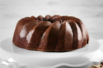 Chocolate cake on plastic mat on wooden background