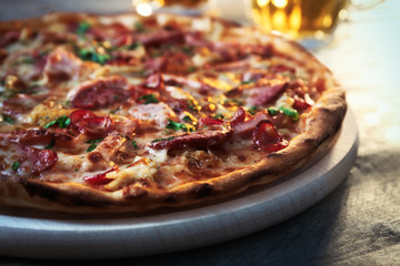 Delicious pizza  and glasses of beer are on wooden table, close up