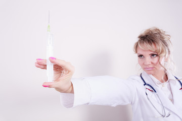 Blonde doctor with syringe.