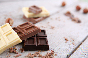 Mix of chocolate with nuts on wooden table