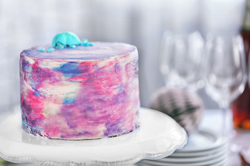 Tasty color cake with macaroon on white stand