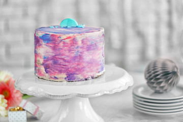 Tasty color cake with macaroon on table