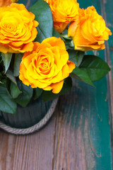 bouquet of orange roses on a wooden background