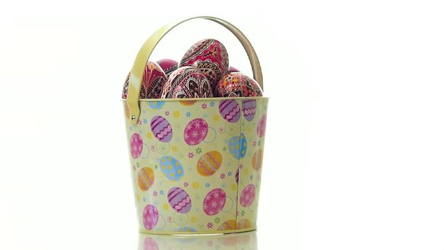 Beautiful ester egg basket turning on a pure white background