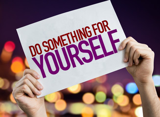 Do Something for Yourself placard with night lights on background