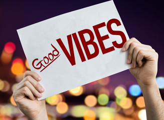 Good Vibes placard with night lights on background