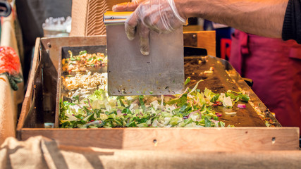 Street Food Vendor Grilling Asian Style Take Away Food.