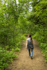 Girls takes a stroll in the woods.