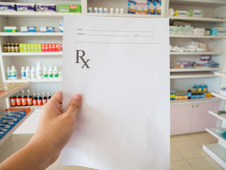 pharmacist with prescription at the pharmacy