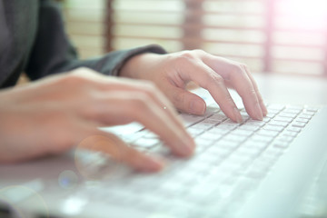business woman hand typing on laptop keyboard