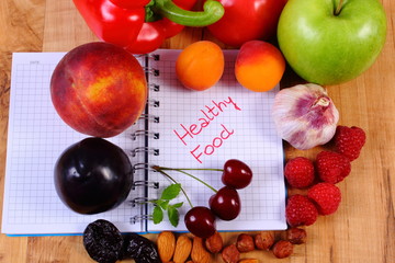 Fruits and vegetables with notebook, slimming and healthy food
