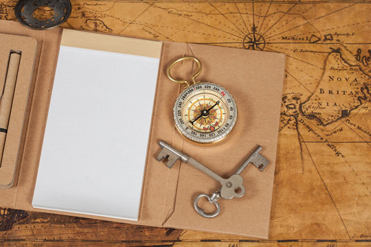 Compass with note book on old map vintage process style