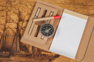Compass with note book on old map vintage process style