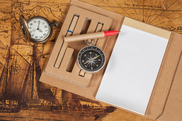 Compass with note book on old map vintage process style