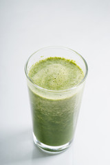 glass of fresh green spinach and kale healthy smoothie