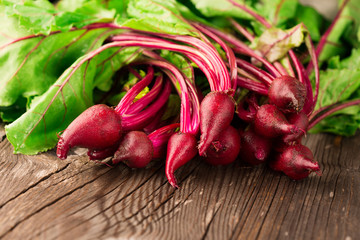 Young beets on wooden background