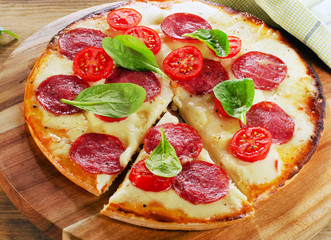 Pizza served on wooden table.