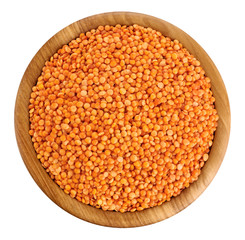 Wooden bowl with lentils isolated on white background.