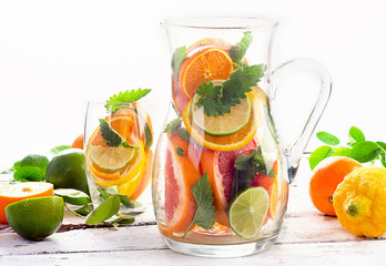 Pitcher and glass with citrus fruits