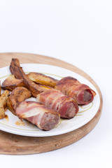 Kebabs rolled in bacon served on a plate